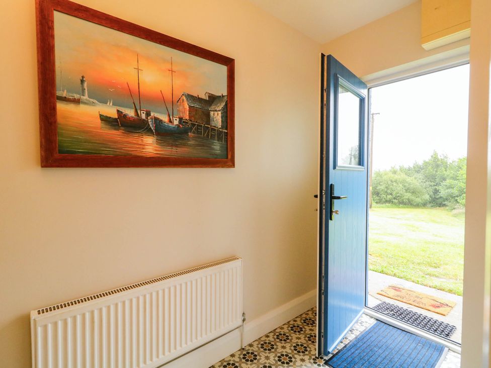 An entryway with a painting and front door at Biddy Granny's