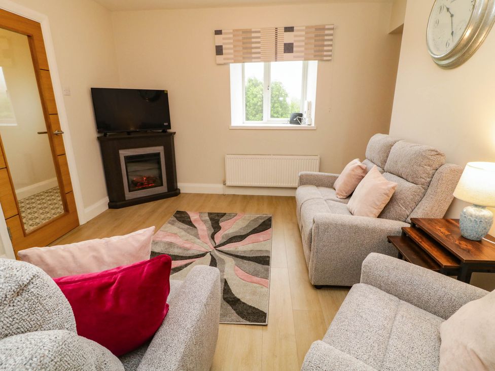 A living room with a sofa and television at Biddy Granny's