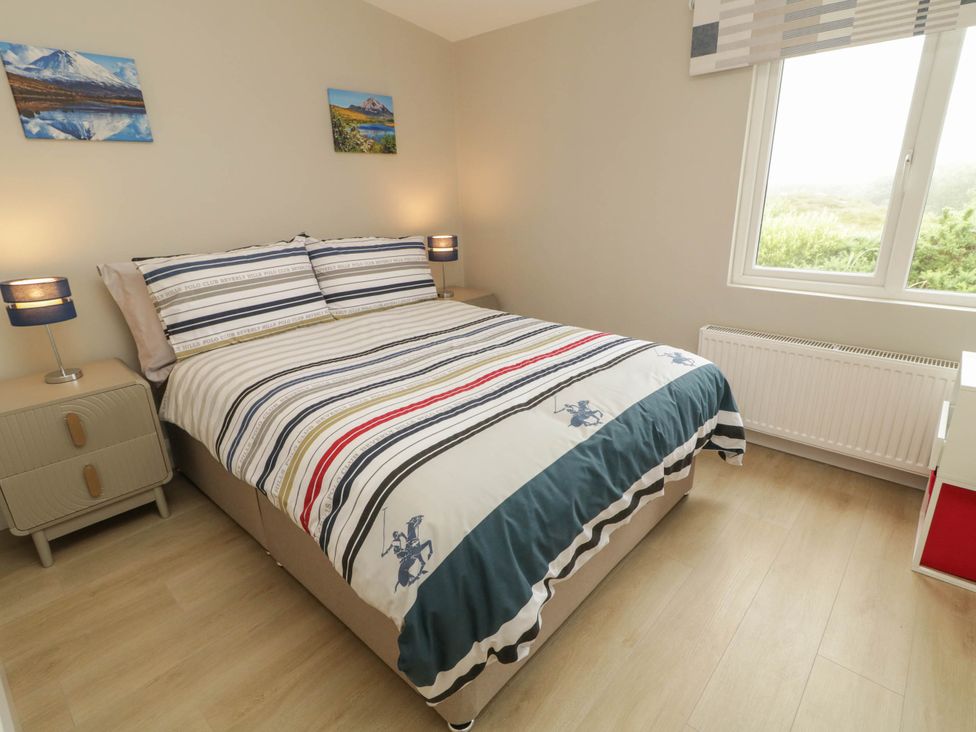 A bedroom with a bed and nightstands at Biddy Granny's 
