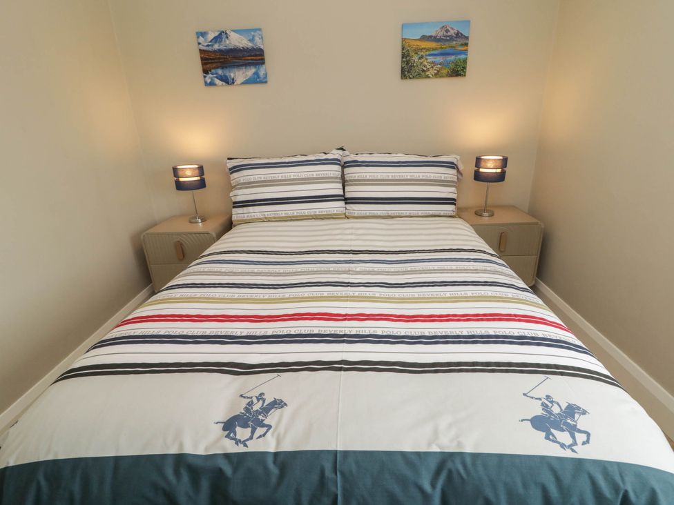 A bedroom with a bed and two nightstands at Biddy Granny's 