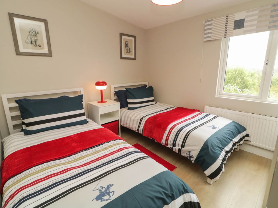 A bedroom with two beds and a window at Biddy Granny's 
