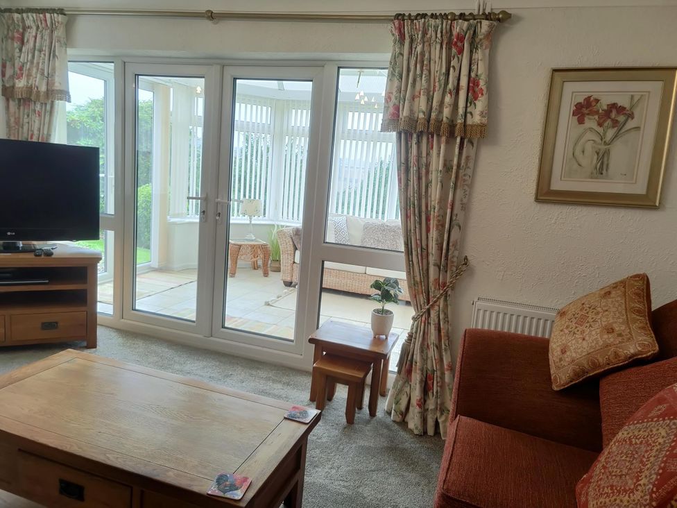 A living room with a television and sofa at Split Level Bungalow Sleeps4 Close to walks in Stanton Hill