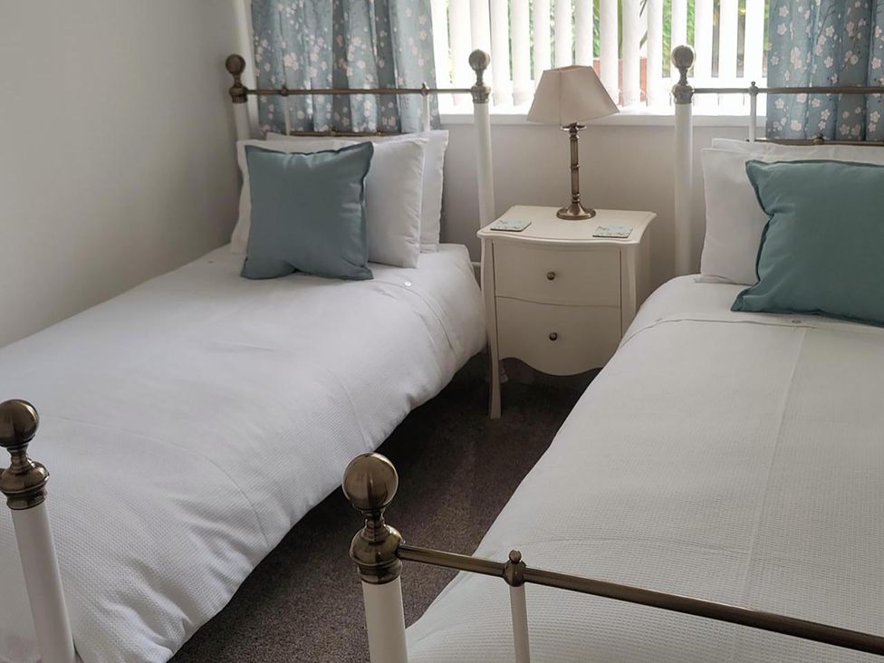 A bedroom with two single beds and a bedside table at Split Level Bungalow Sleeps4 Close to walks Stanton Hill