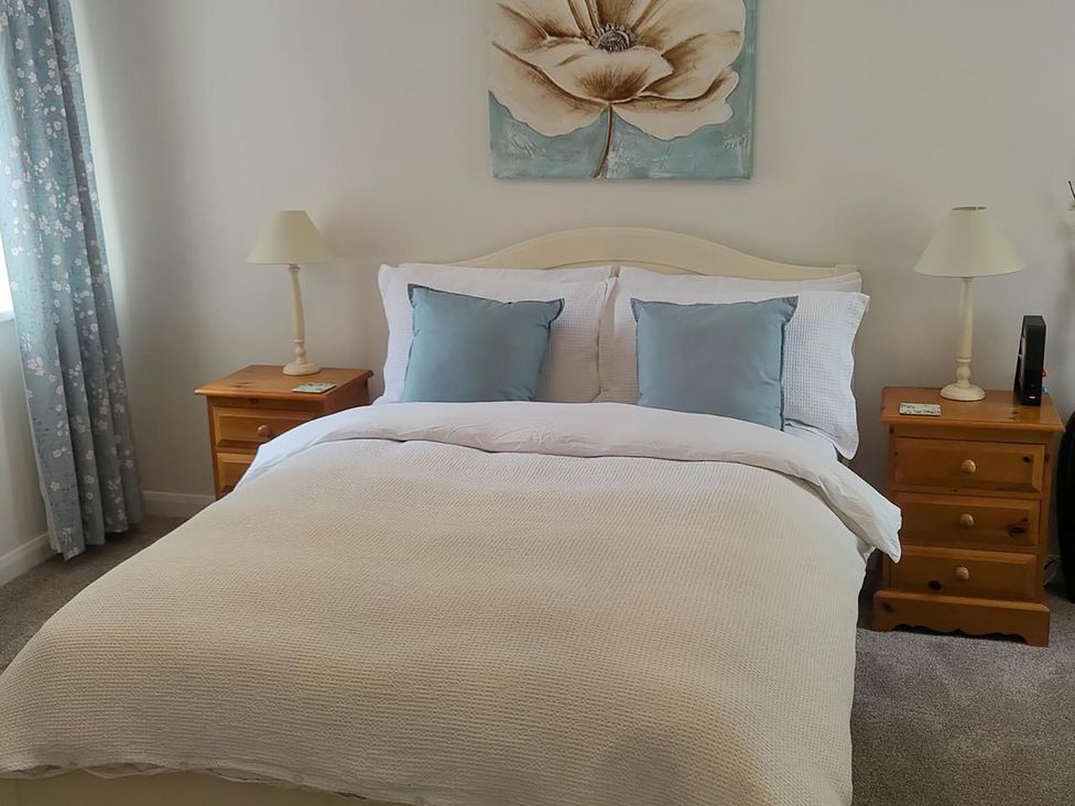 A bedroom with a bed and nightstand at Split Level Bungalow Sleeps4 Close to walks Stanton Hill