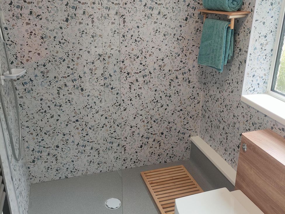 A bathroom with a shower and towels at Split Level Bungalow Sleeps4 Close to walks Stanton Hill