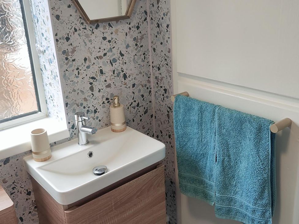 A bathroom with a sink and towel at Split Level Bungalow Sleeps4 Close to walks Stanton Hill