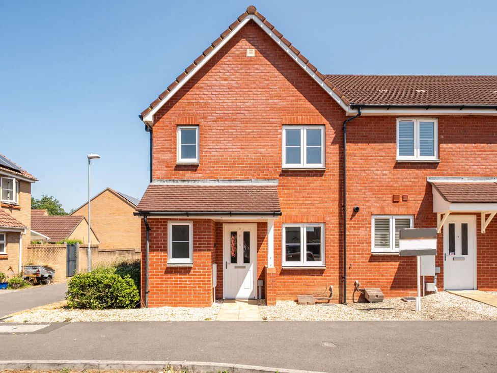A brick house with a garden pathway and mailbox at House Sleeps 6 Enclosed Garden Pet Friendly in Bridgwater