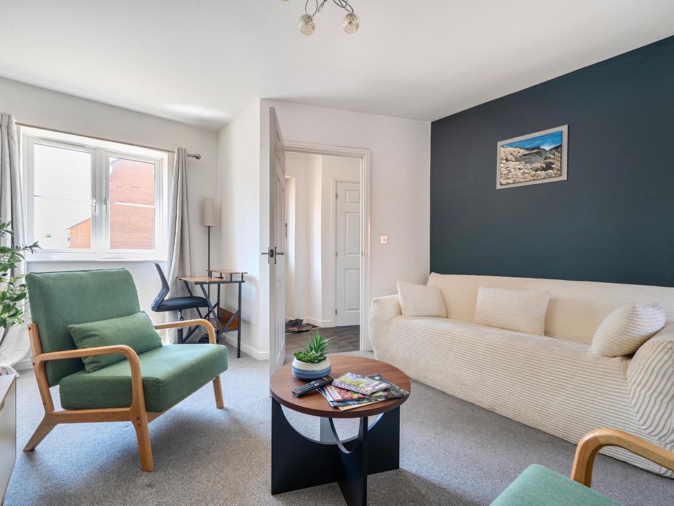 A living room with a sofa and armchair at House Sleeps 6 Enclosed Garden Pet Friendly in Bridgwater