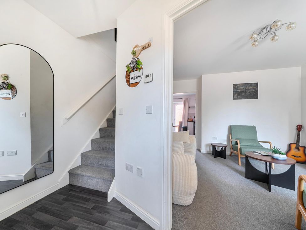 A living room with a staircase and seating area at House Sleeps 6 Enclosed Garden Pet Friendly in Bridgwater