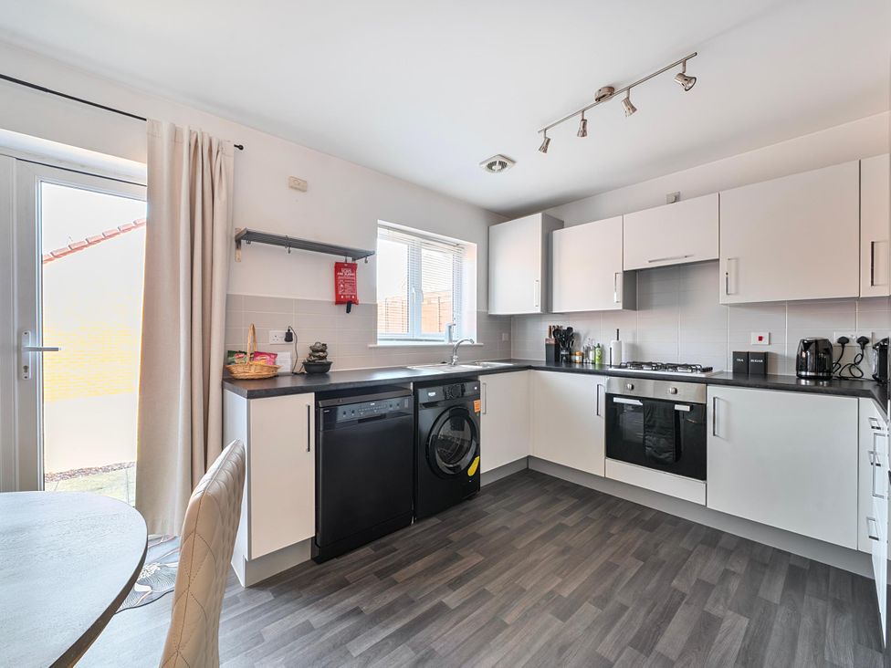 A kitchen with appliances and cabinetry at House Sleeps 6 Enclosed Garden Pet Friendly in Bridgwater