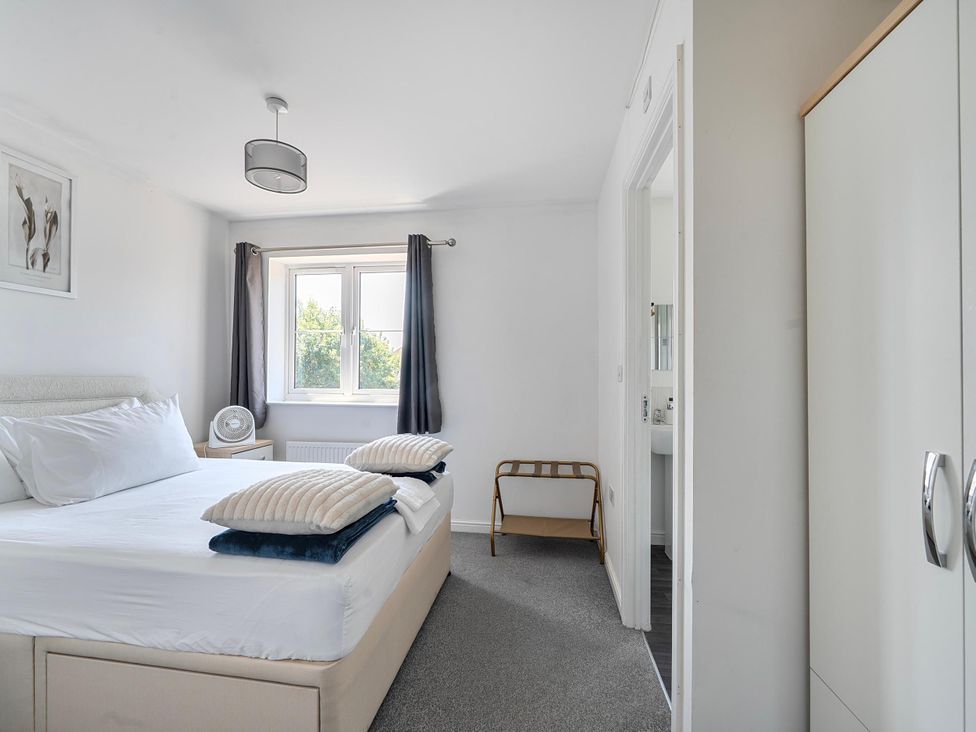A bedroom with a bed and window at House Sleeps 6 Enclosed Garden Pet Friendly in Bridgwater
