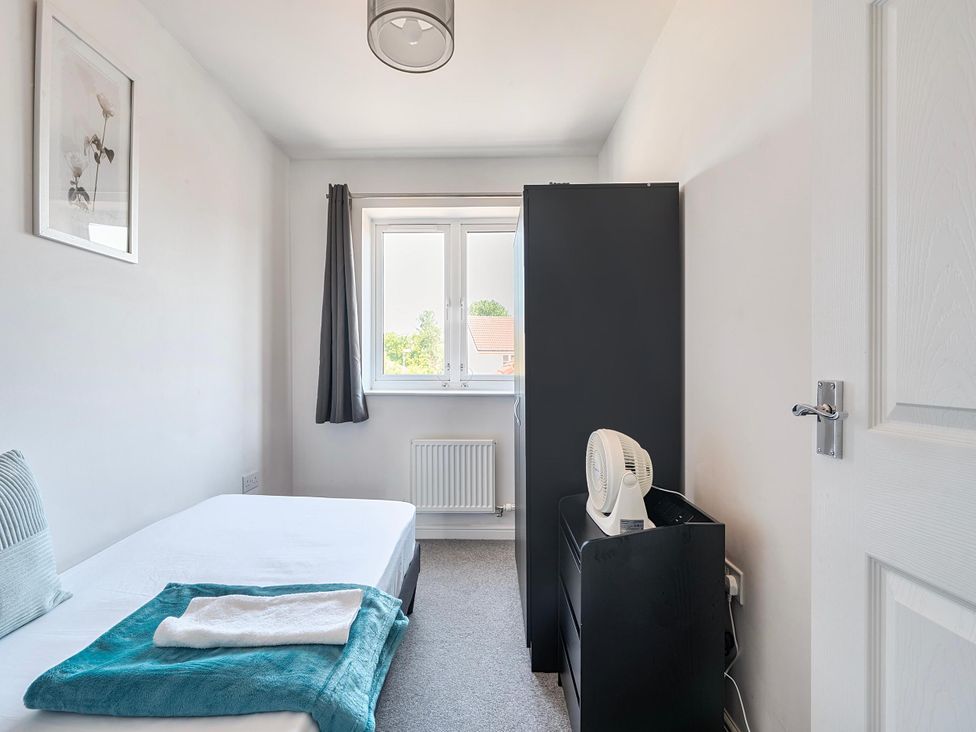 A bedroom with a bed and wardrobe at House Sleeps 6 Enclosed Garden Pet Friendly in Bridgwater