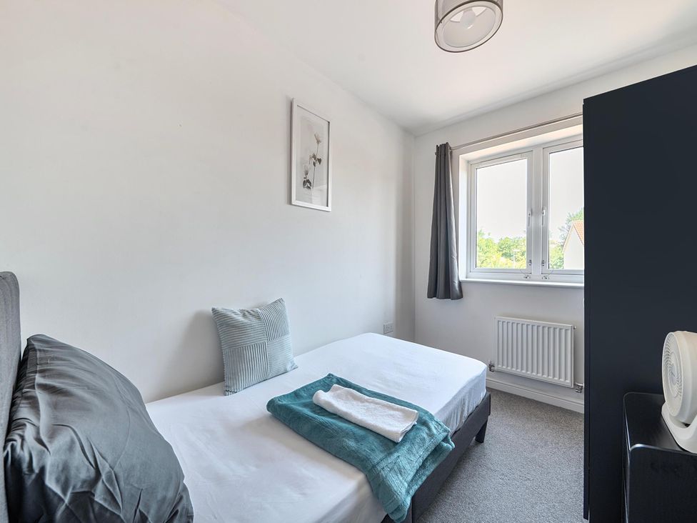 A bedroom with a bed and window at House Sleeps 6 Enclosed Garden Pet Friendly in Bridgwater