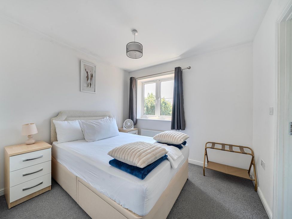 A bedroom with bed and nightstand at House Sleeps 6 Enclosed Garden Pet Friendly Bridgwater