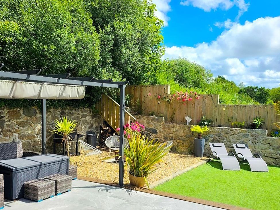 A garden with seating and plants at 4 Bed Villa Sleeps 8 Private Terrace Free parking Near St Austell