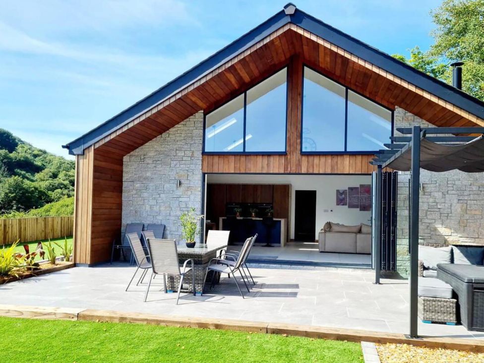 An outdoor area with seating and tables at 4 Bed Villa Sleeps 8 Private Terrace Free parking Near St Austell