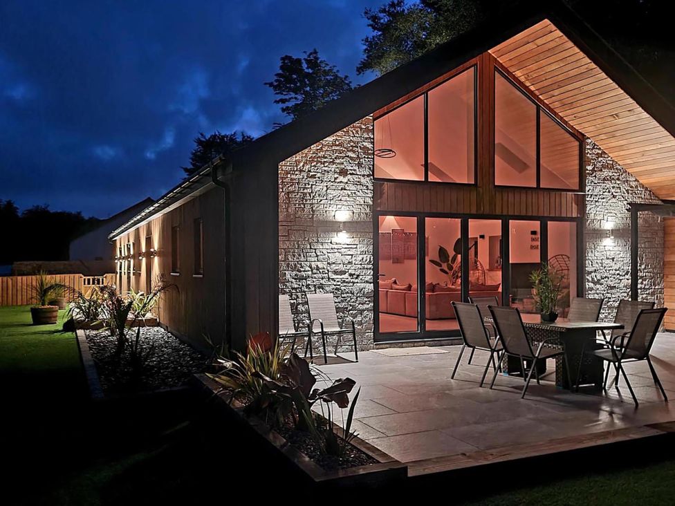 A house exterior with a terrace and table near St Austell
