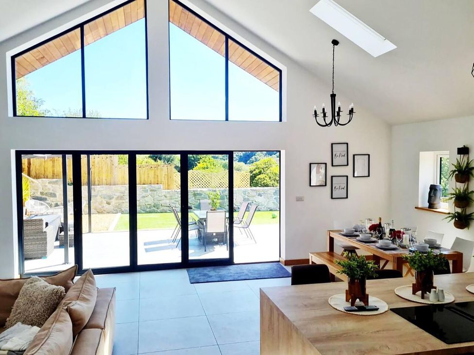 A living room with a view of the garden at 4 Bed Villa Sleeps 8 Private Terrace Free parking near St Austell