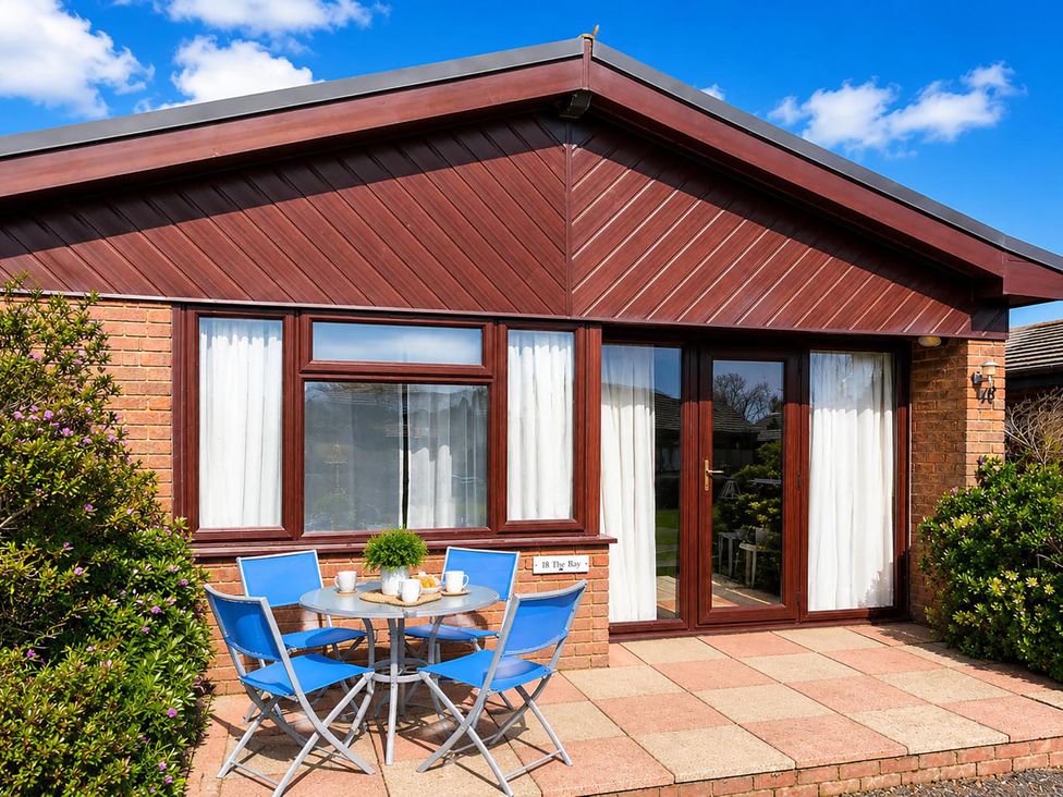 A house with outdoor seating at Coastal Chalet Retreat in St Margaret's Bay