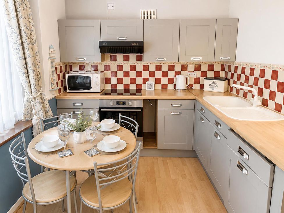 A kitchen with a table and chairs at Coastal Chalet Retreat in St Margaret's Bay