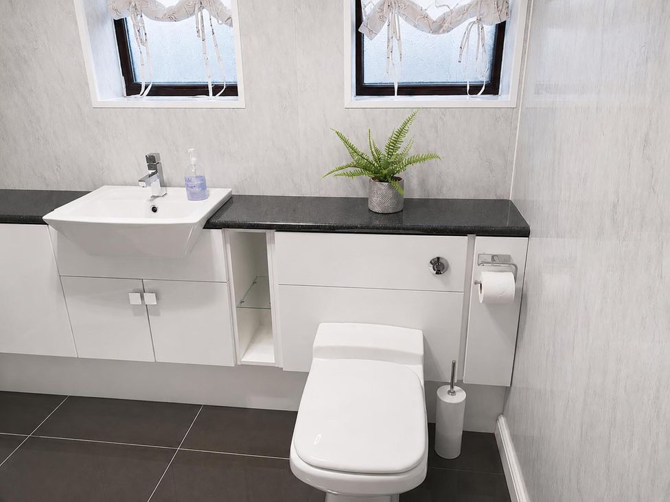 A bathroom with a sink and toilet at Coastal Chalet Retreat in St Margaret's Bay