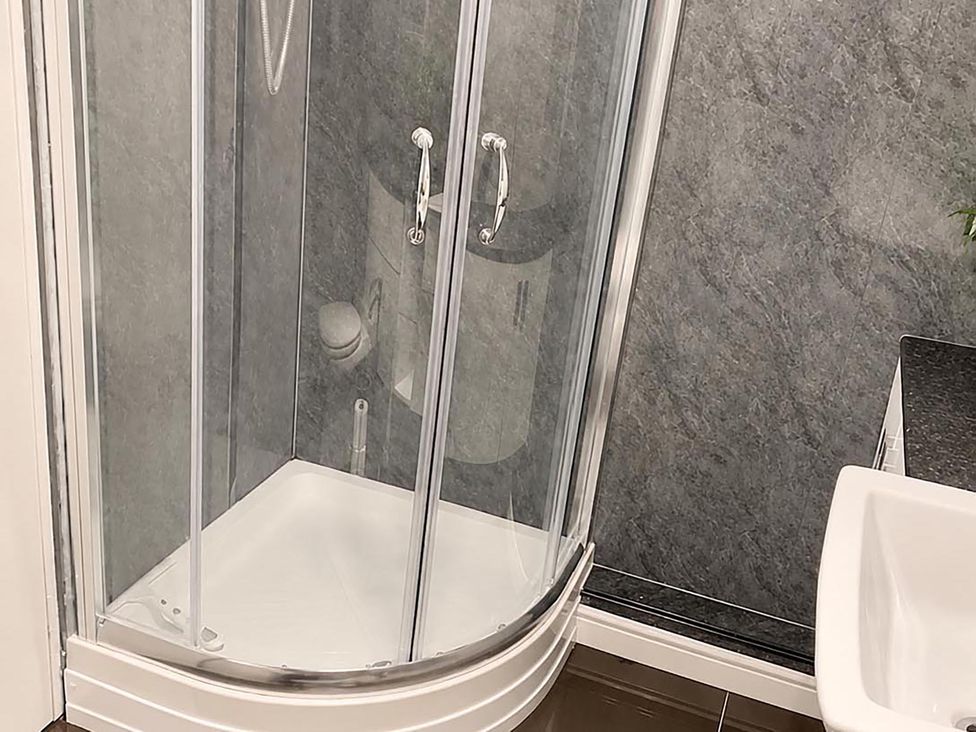 A bathroom with a shower and toilet at Coastal Chalet Retreat in St Margaret's Bay