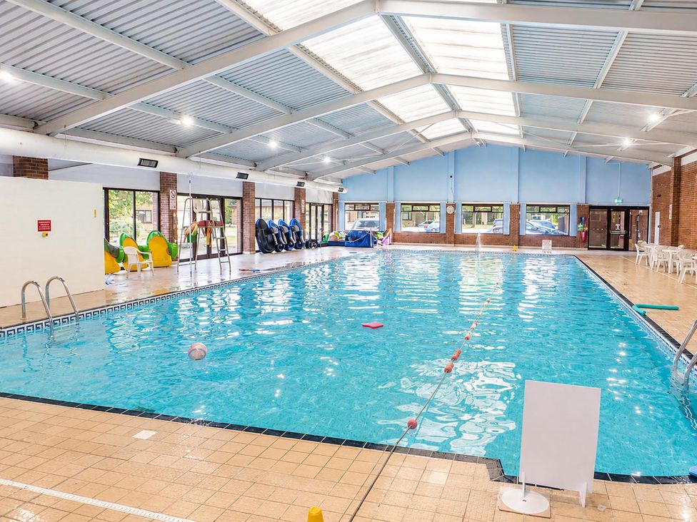 An indoor pool with a ladder and safety buoy at Coastal Chalet Retreat in St Margaret's Bay