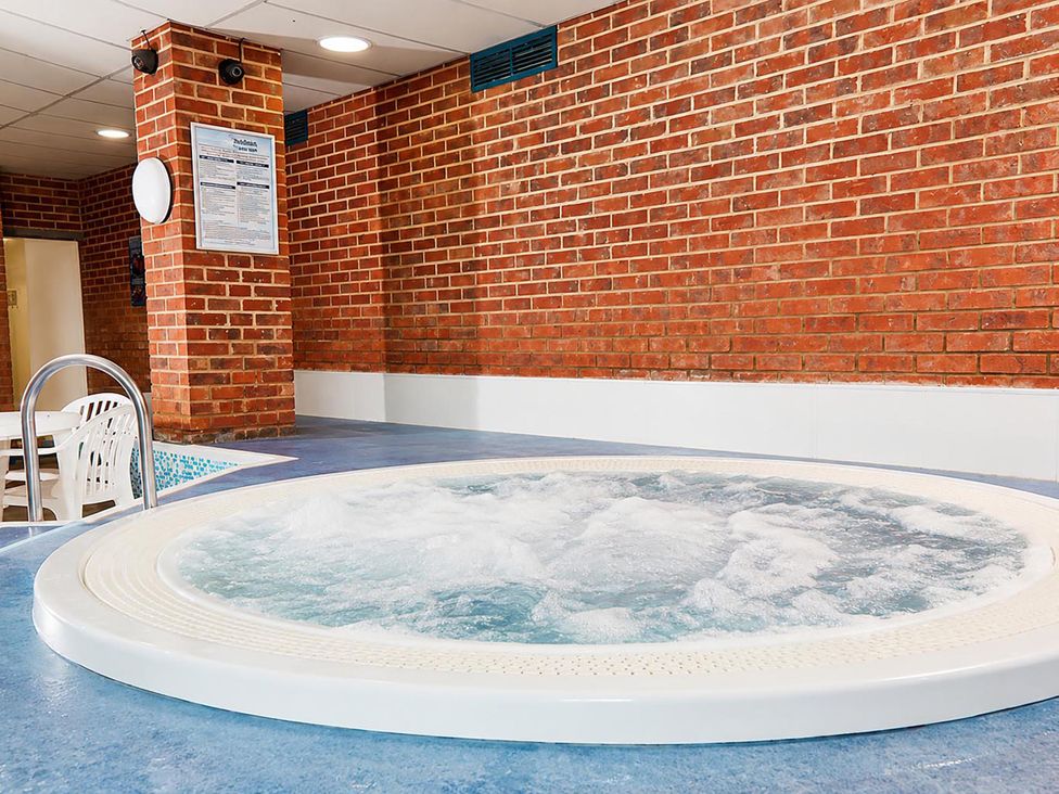 A hot tub in an indoor pool area at Coastal Chalet Retreat in St Margaret's Bay