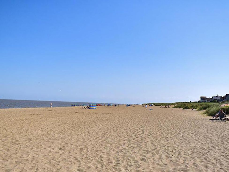 A beach with sand and sea at Sandy Paws Dog Friendly Anderby Creek