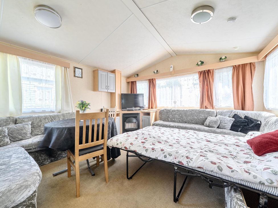A living room with a dining table and sofa at 3 Bed Caravan Sleeps 8 Pets Garden Parking Hull