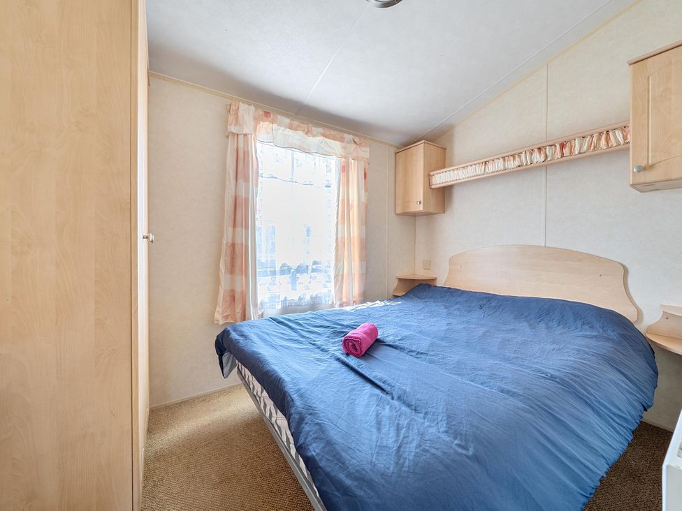 A bedroom with a bed and wardrobe at 3 Bed Caravan Sleeps 8 Pets Garden Parking in Hull
