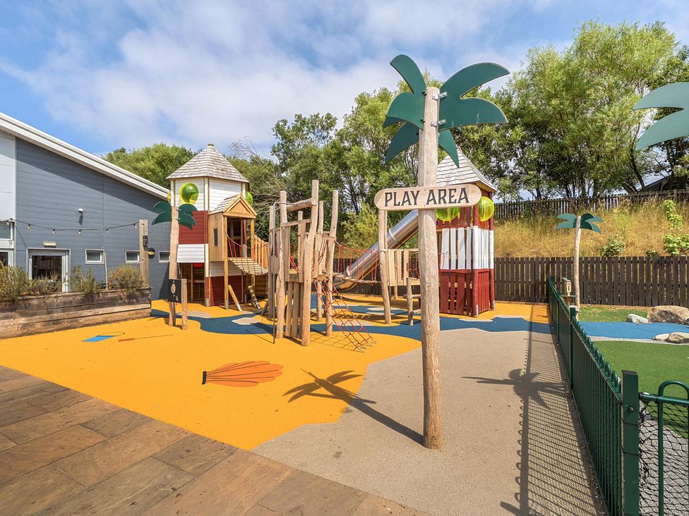 A playground with a play structure and slide at a play area