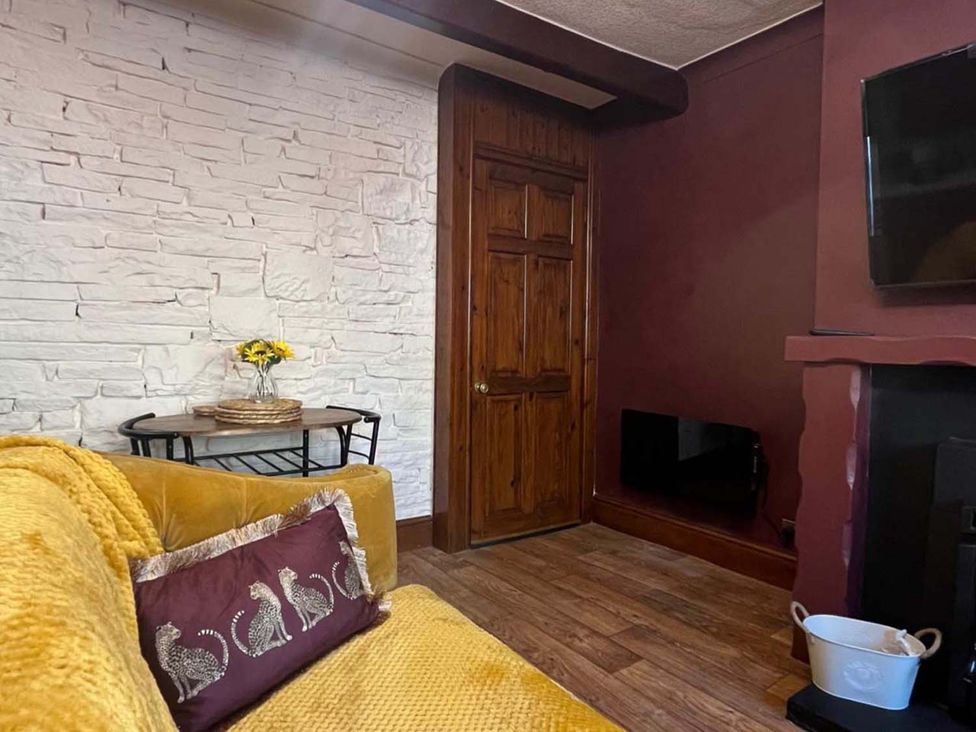 A living room with a sofa and a table at Cozy Cottage Retreat near Haworth log burner, Keighley