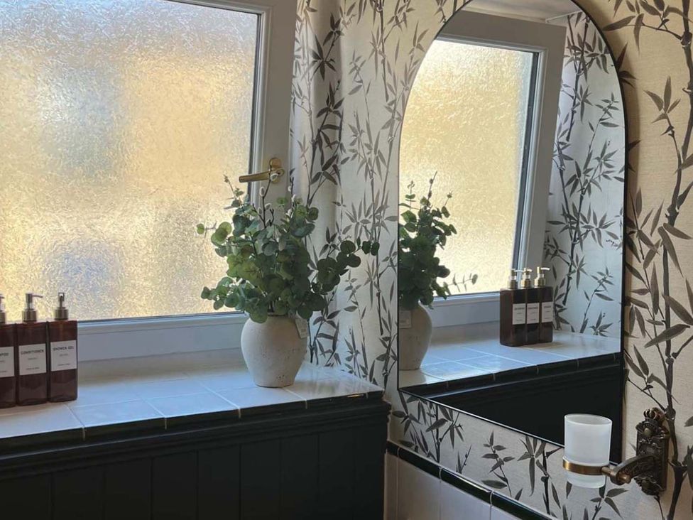 A bathroom with a mirror and plants at Cozy Cottage Retreat near Haworth log burner, Keighley