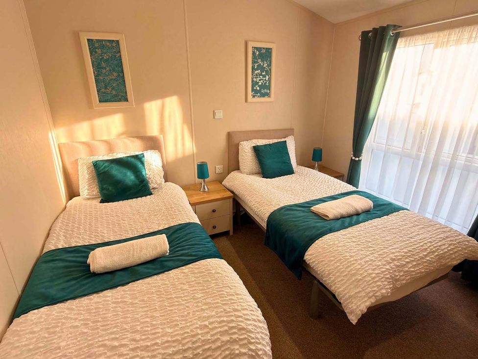 A bedroom with twin beds and a bedside table at The Old Barn in Manchester