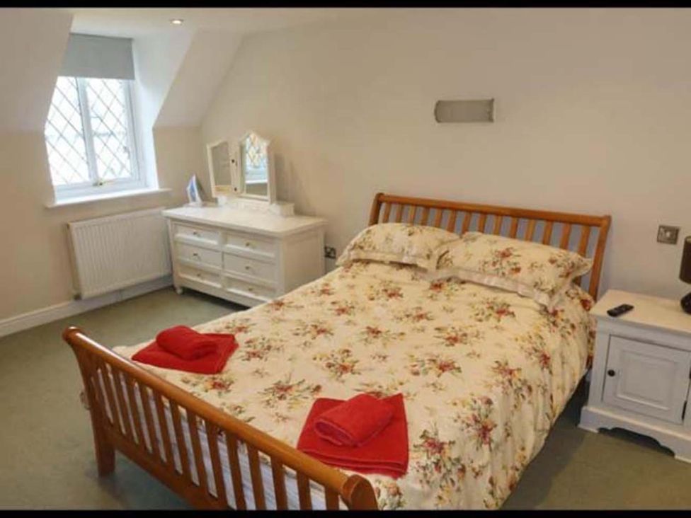 A bedroom with a bed and dresser at The Old Barn in Manchester