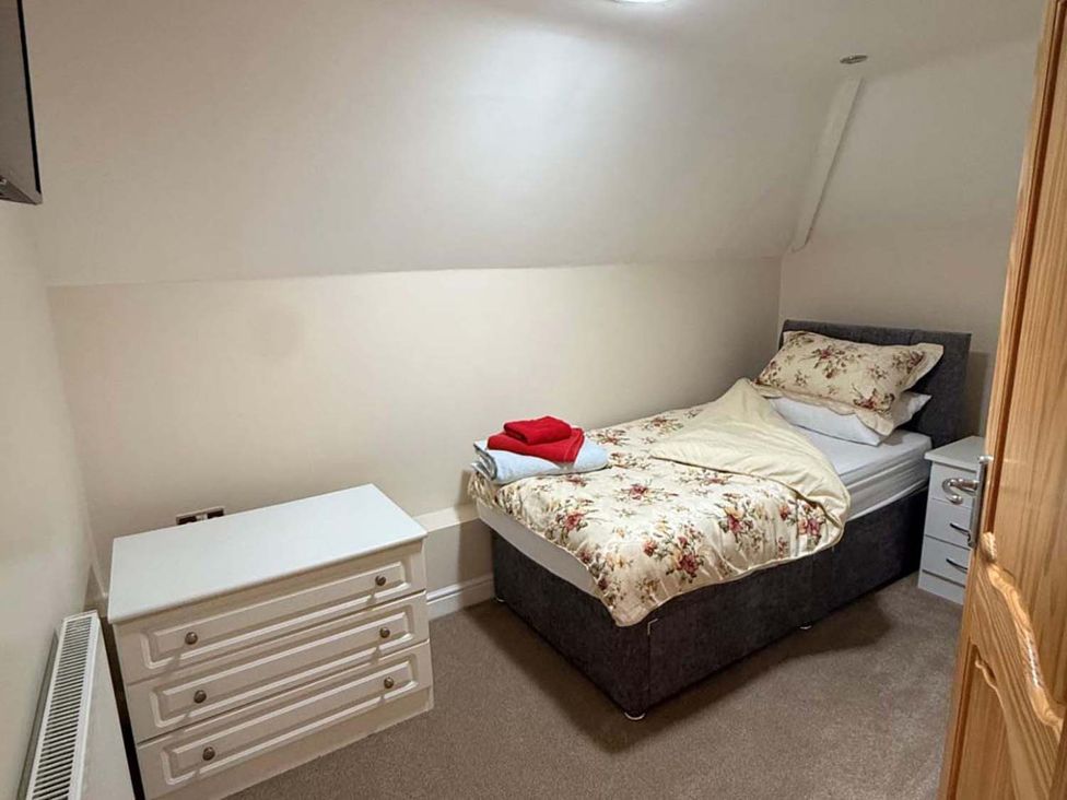 A bedroom with a bed and dresser at 
