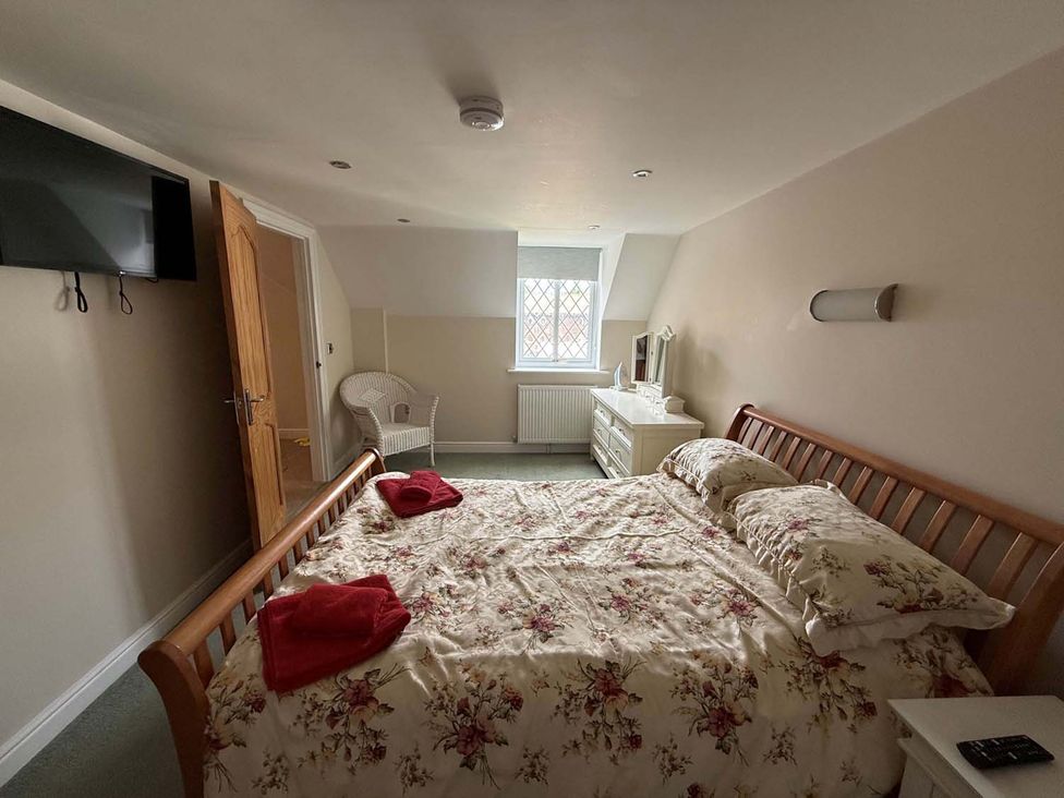A bedroom with a bed and television at The Old Barn in Manchester