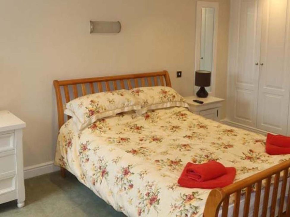 A bedroom with a bed and bedside table at The Old Barn in Manchester