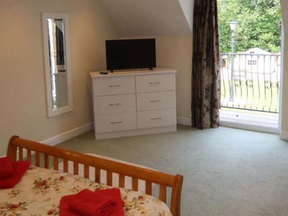 A bedroom with a bed and a dresser at the property in location