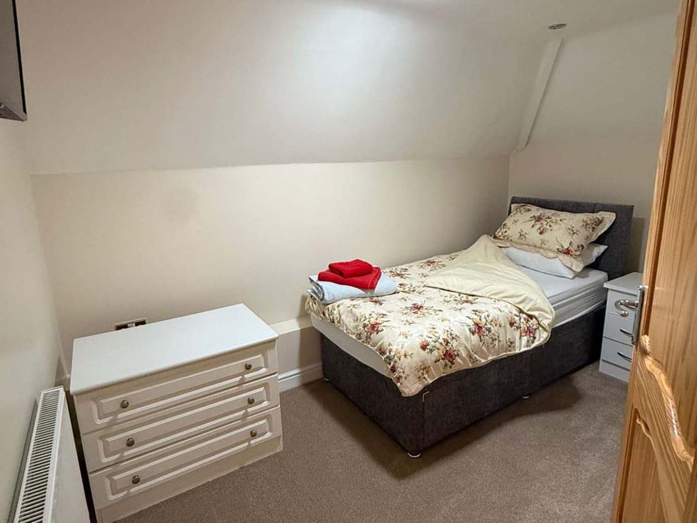 A bedroom with a bed and dresser at 