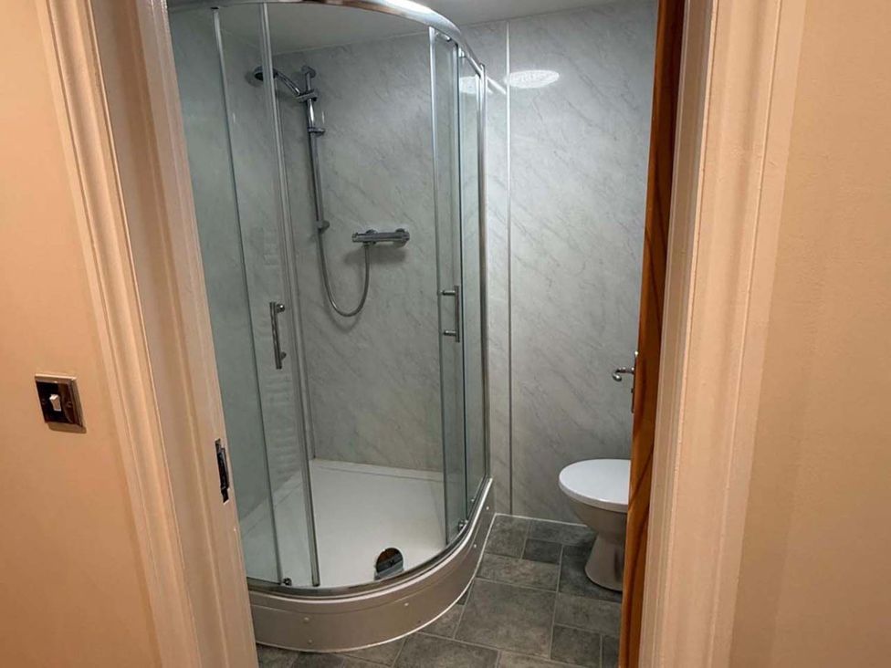 A bathroom with a shower and toilet at The Old Barn in Manchester