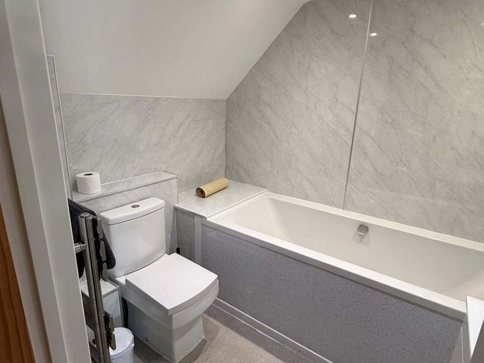 A bathroom with a bathtub and toilet at 