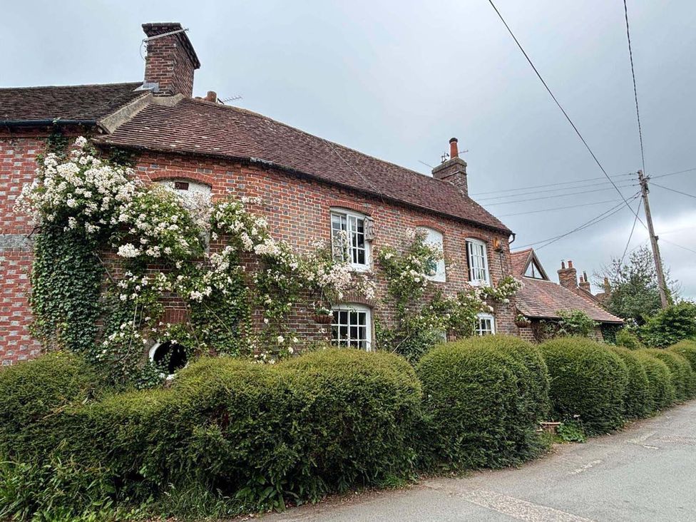 A house with a brick exterior and flowers near the windows in a residential area