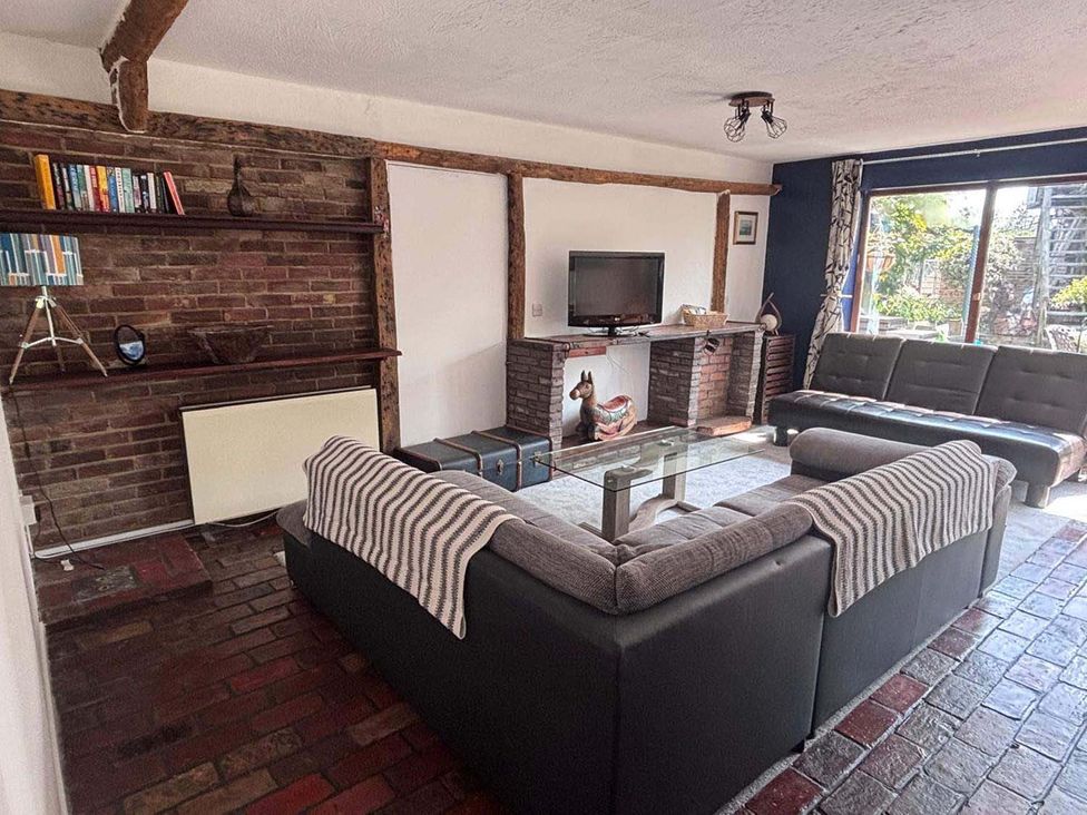 A living room with a sofa and a coffee table at The Old Barn in Manchester