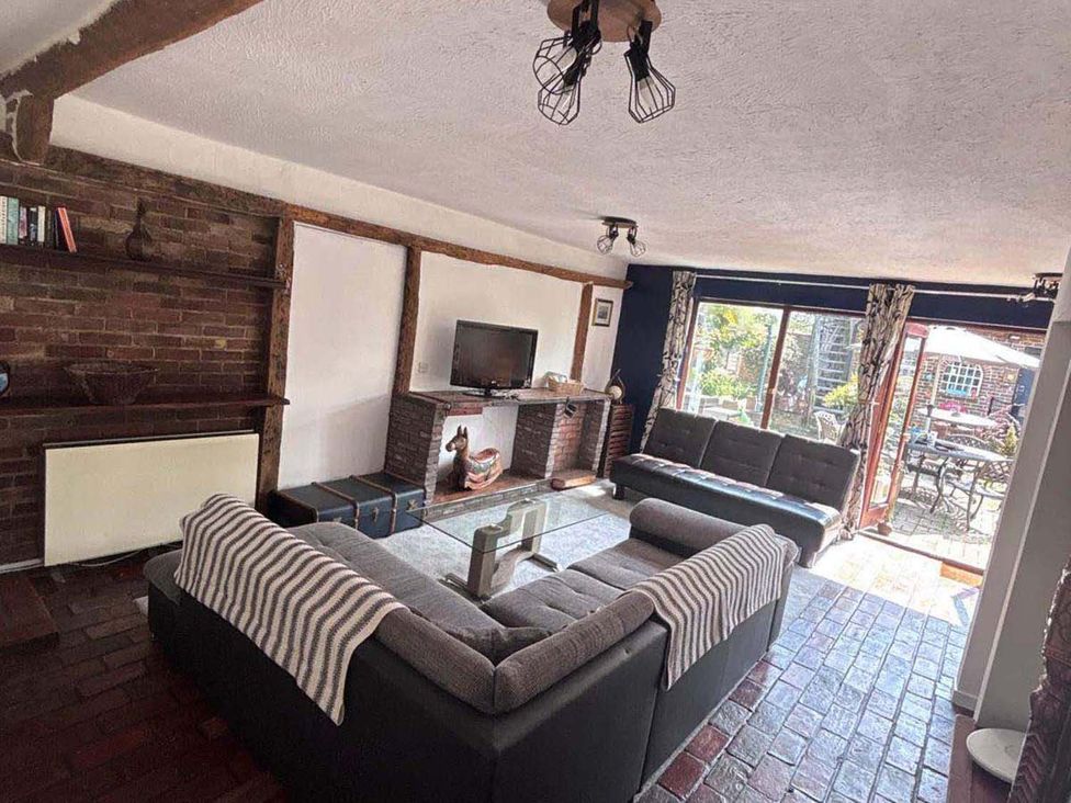 A living room with a sofa and television at a property