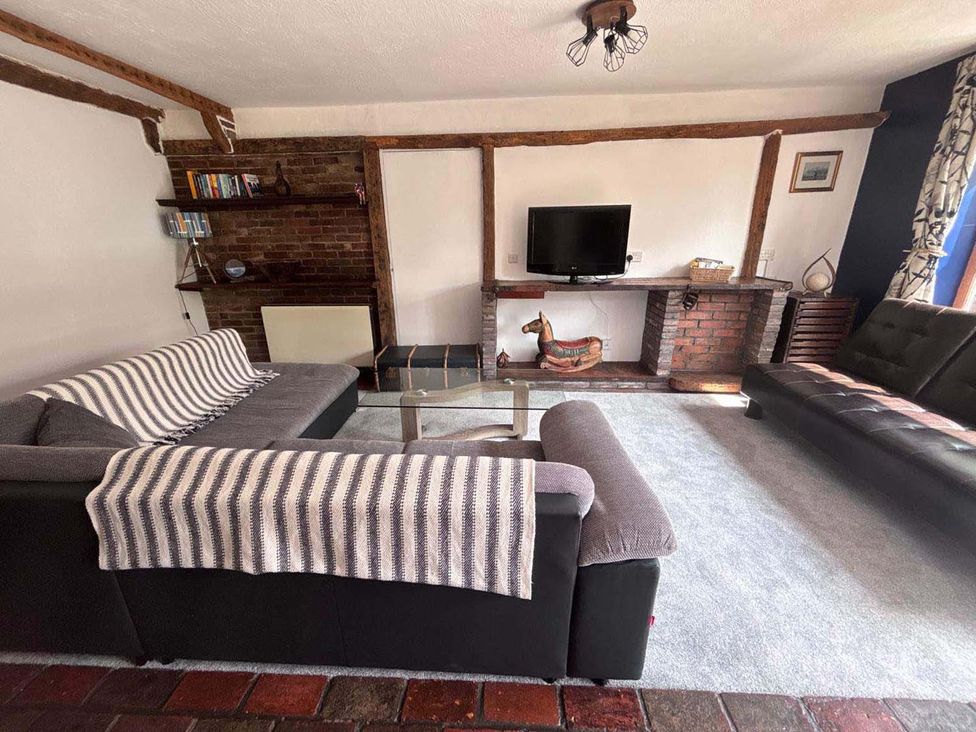 A living room with a sofa and a television at the property in the city