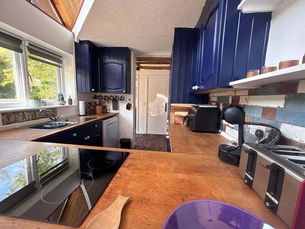 A kitchen with countertop, sink and appliances at the property in 
