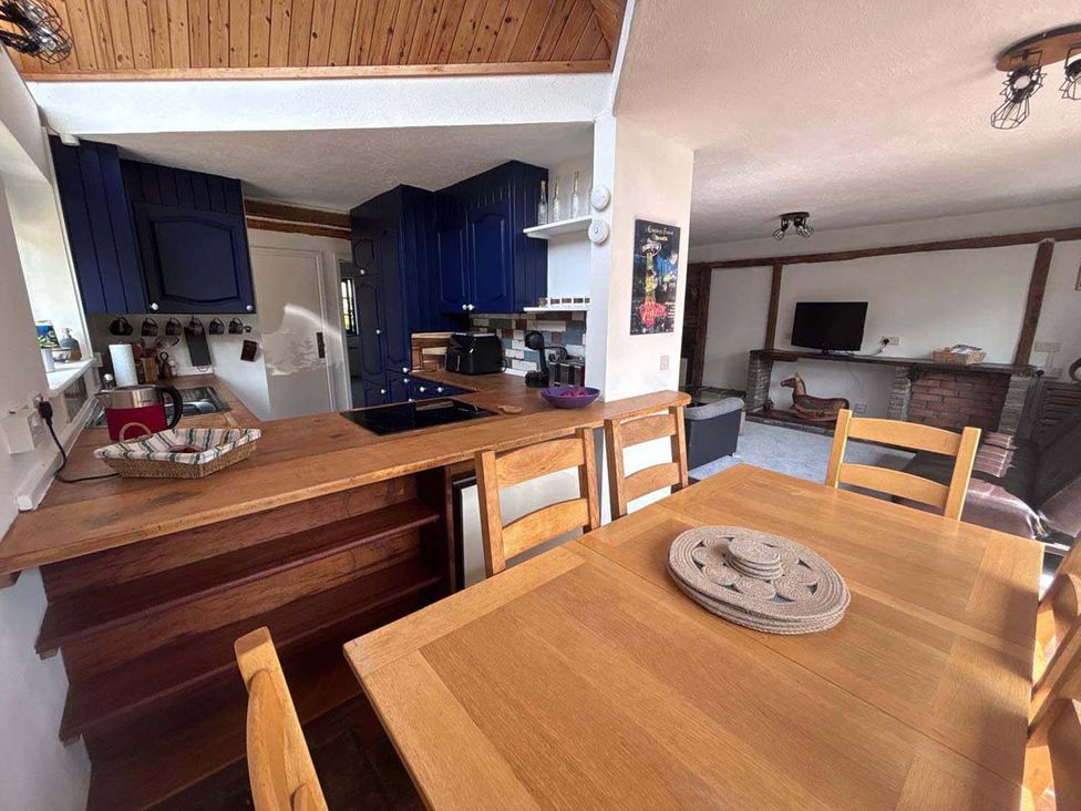 A kitchen with wooden countertops and blue cabinets at The Old Barn in Manchester