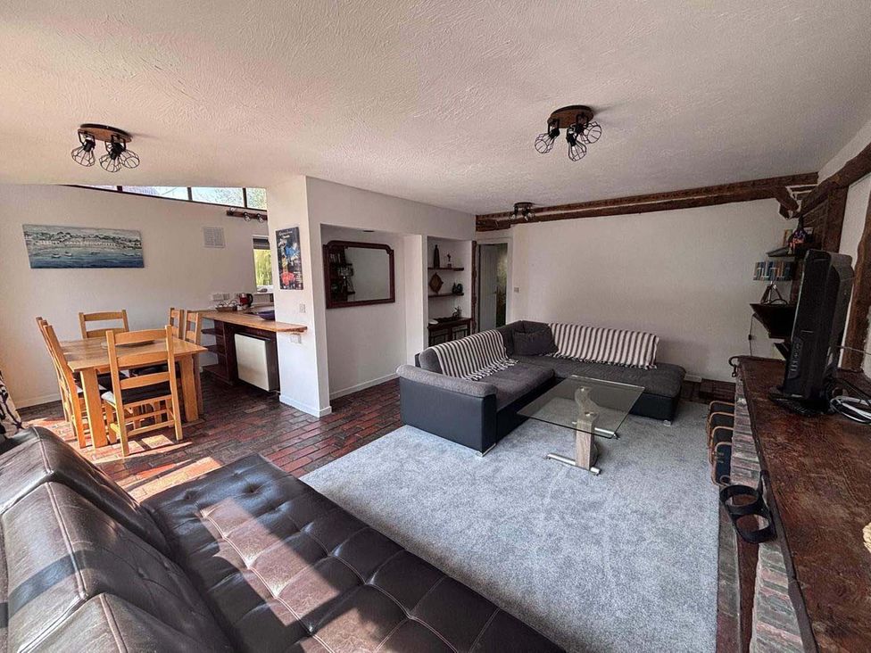 A living room featuring a sofa and dining table at the property